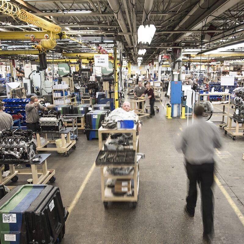 Men working on engines in warehouse